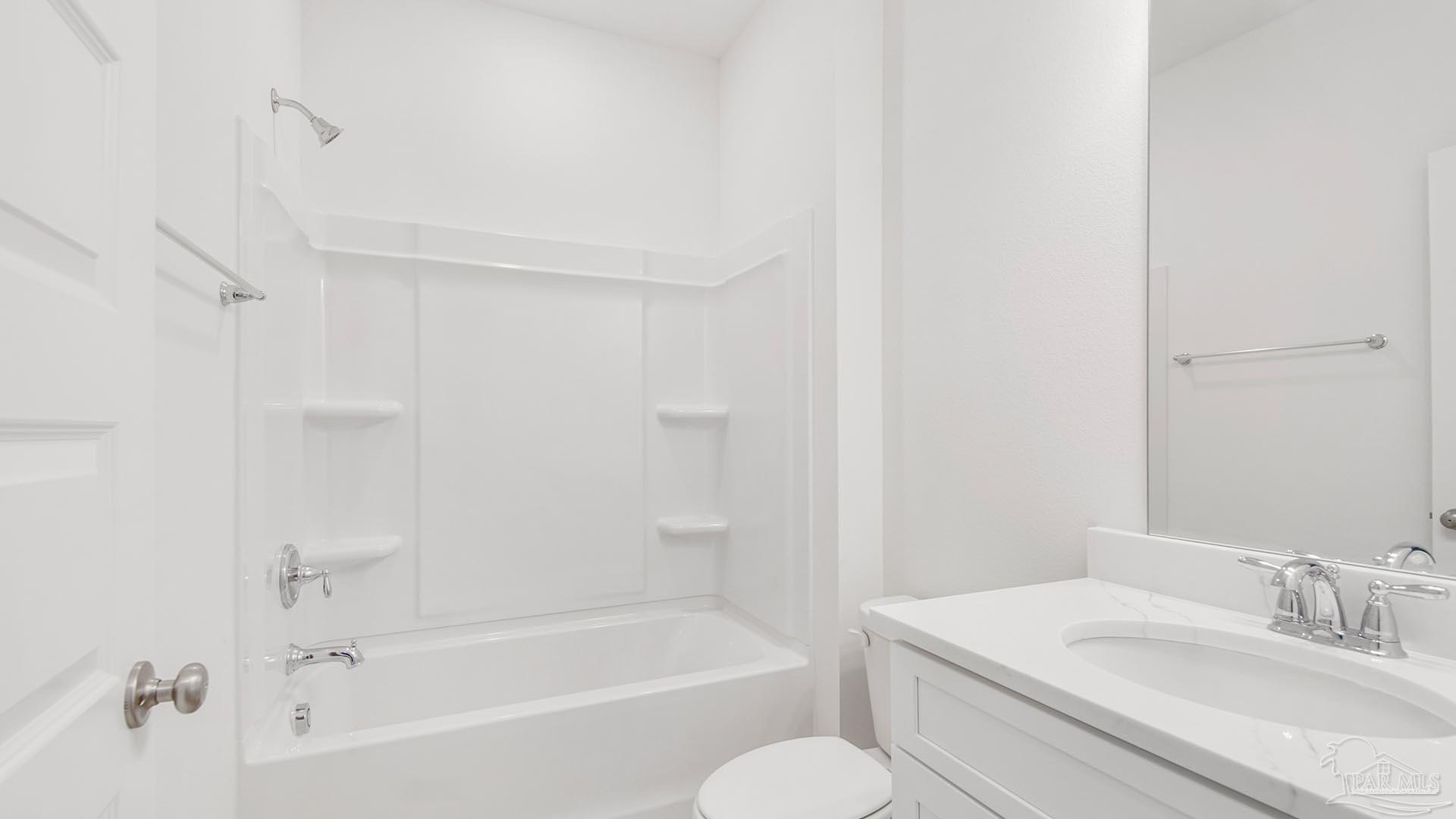 3233 Harrier Road Pace, FL 32571 - Photo 31 of 50 a bathroom with a bathtub shower sink vanity and toilet