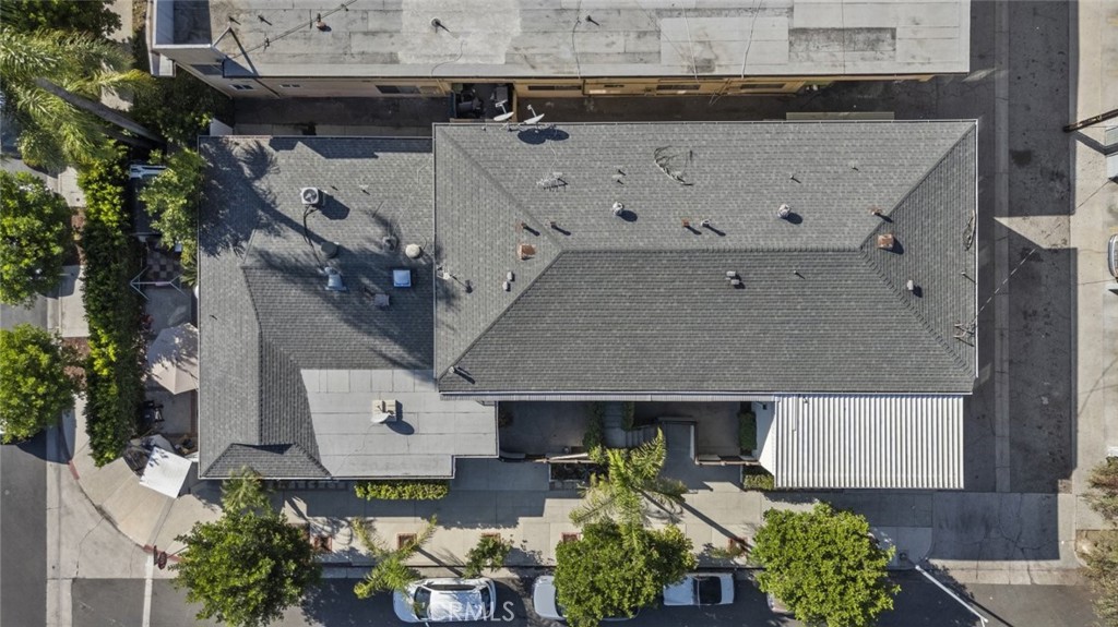 an aerial view of a house with a yard and potted plants