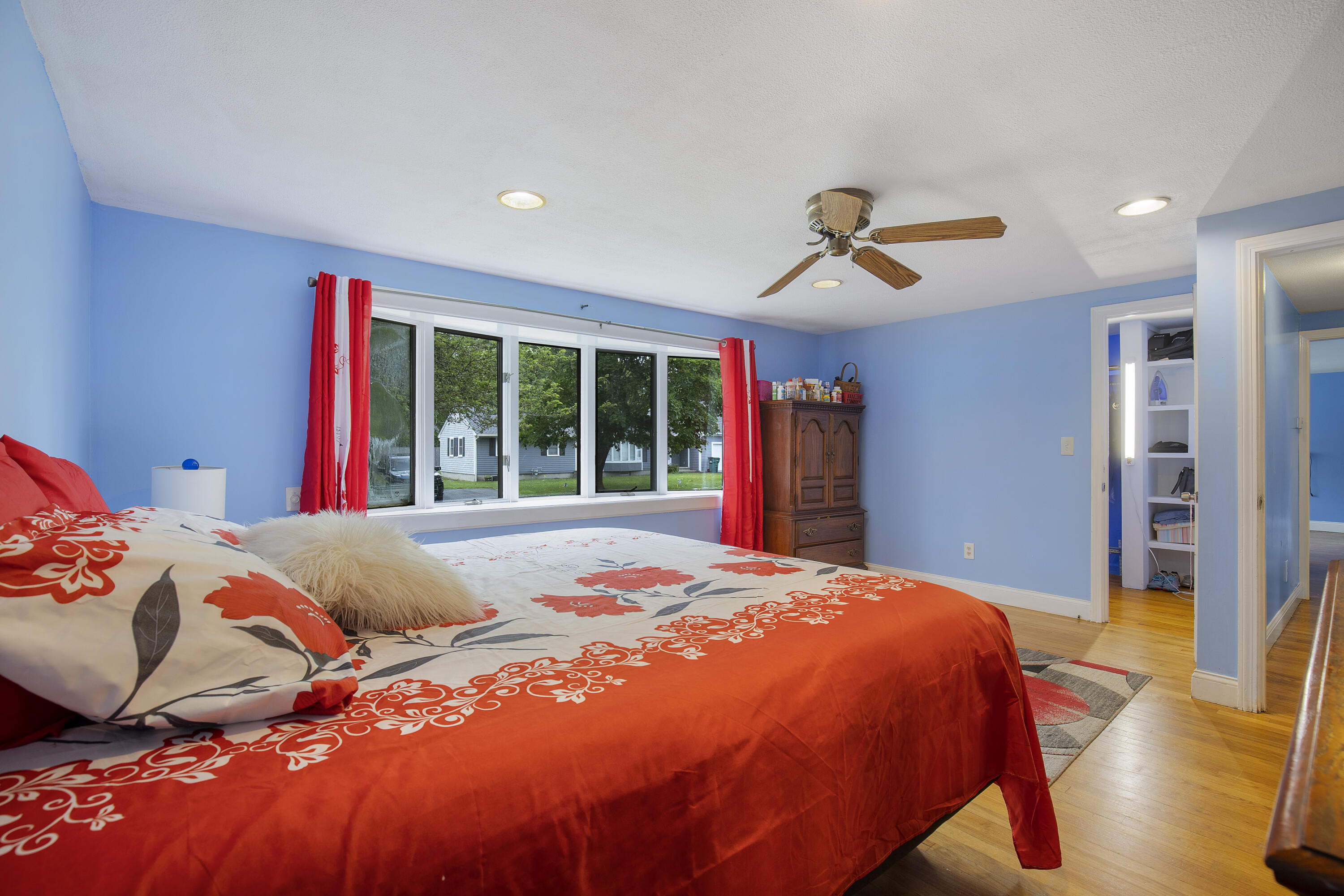 298 Oakland Road Hyannis, MA 02601 - Photo 8 of 25 a bedroom with a large bed and a chandelier
