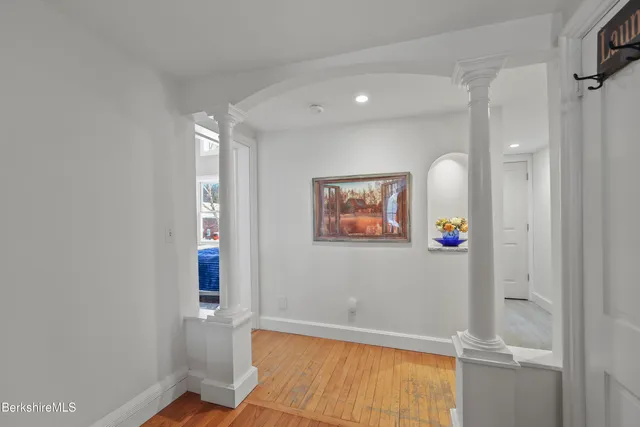 a living room with furniture a flat screen tv and a large window