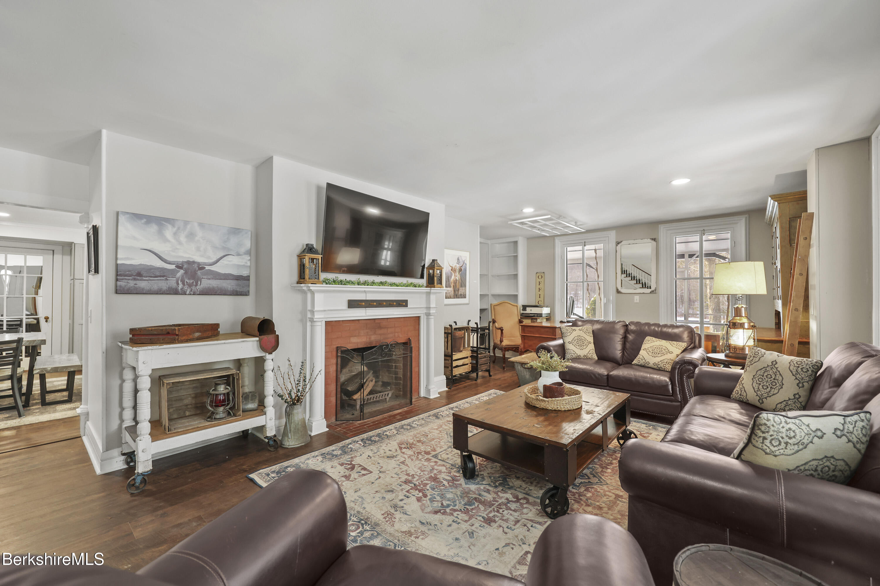 295 Blair Road Williamstown, MA 01267 - Photo 4 of 115 a living room with furniture a fireplace and a flat screen tv