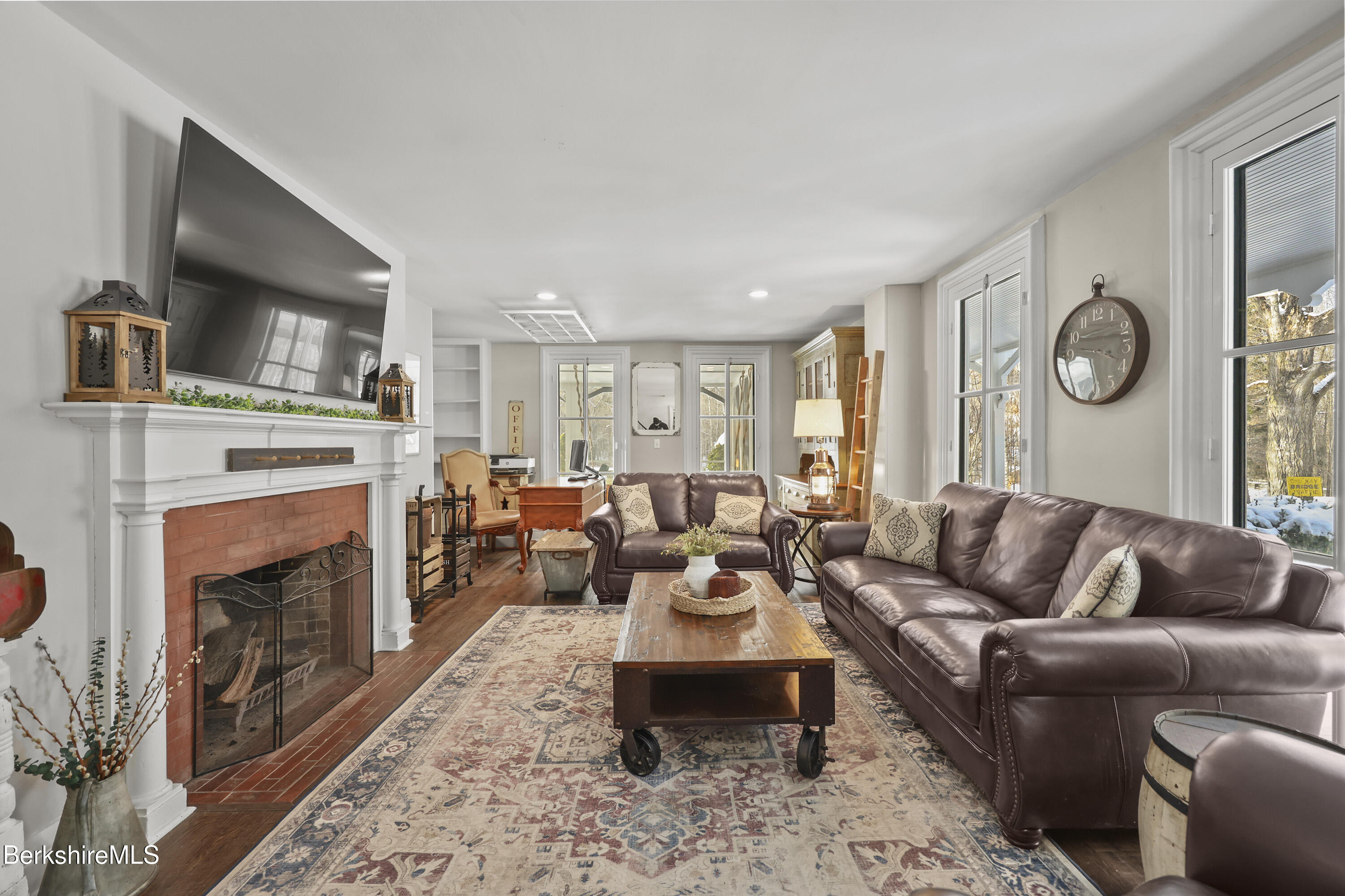 295 Blair Road Williamstown, MA 01267 - Photo 5 of 115 a living room with furniture a fireplace and a flat screen tv