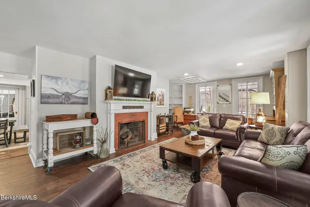 a living room with furniture a fireplace and a flat screen tv