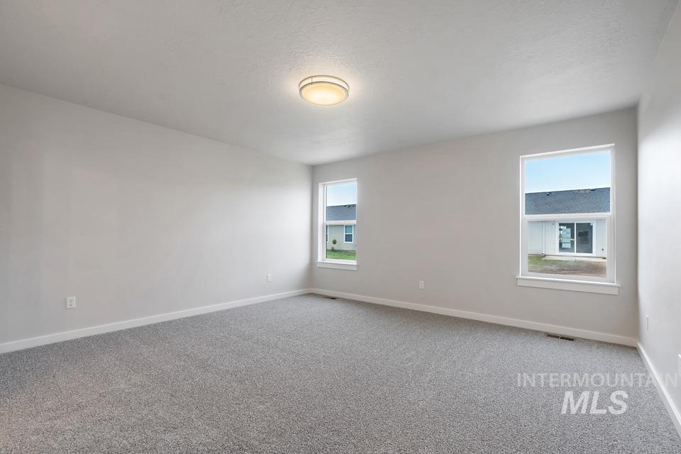 1355 Crescent Street Weiser, ID 83672 - Photo 17 of 31 Carpeted empty room with baseboards