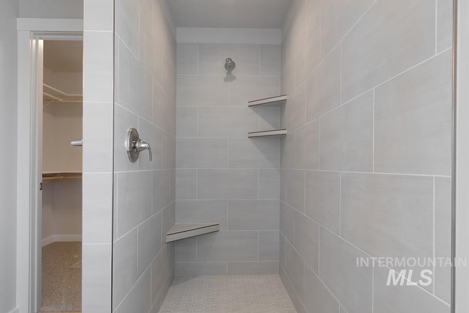 1355 Crescent Street Weiser, ID 83672 - Photo 21 of 31 Bathroom with a tile shower and a walk in closet