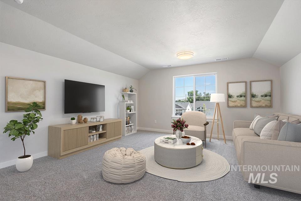 1355 Crescent Street Weiser, ID 83672 - Photo 24 of 31 Carpeted living area with lofted ceiling
