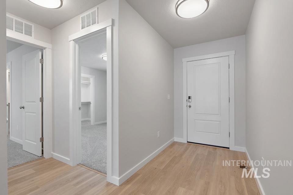 1355 Crescent Street Weiser, ID 83672 - Photo 4 of 31 Hall featuring light wood-type flooring and baseboards