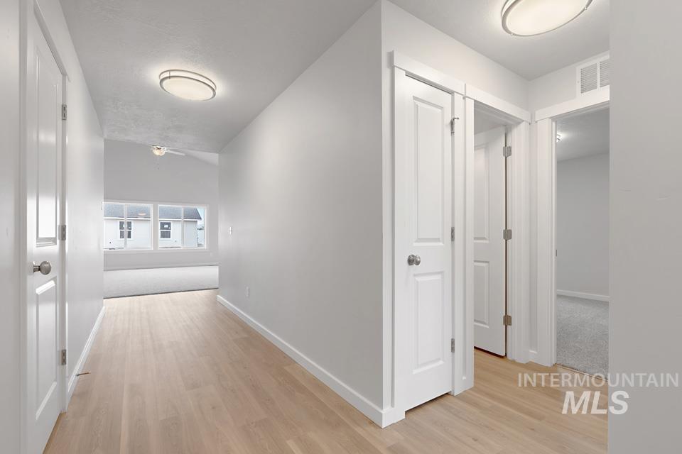 1355 Crescent Street Weiser, ID 83672 - Photo 5 of 31 Hallway with light wood-style flooring and baseboards