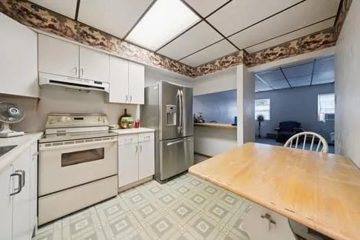 a kitchen with stainless steel appliances granite countertop a sink a stove and refrigerator