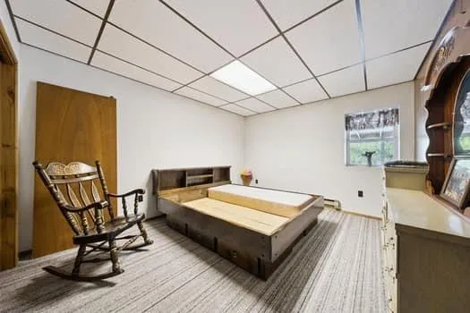 a spacious bedroom with a bed and a table
