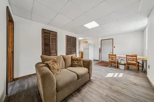 a living room with furniture and a wooden floor