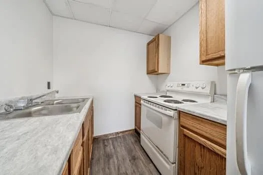 a kitchen with a sink stove top oven and cabinets