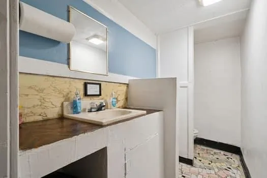 a bathroom with a sink and a mirror