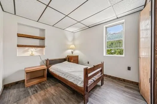 a bedroom with a bed and a window