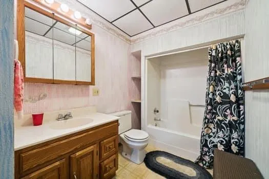 a bathroom with a sink toilet and shower