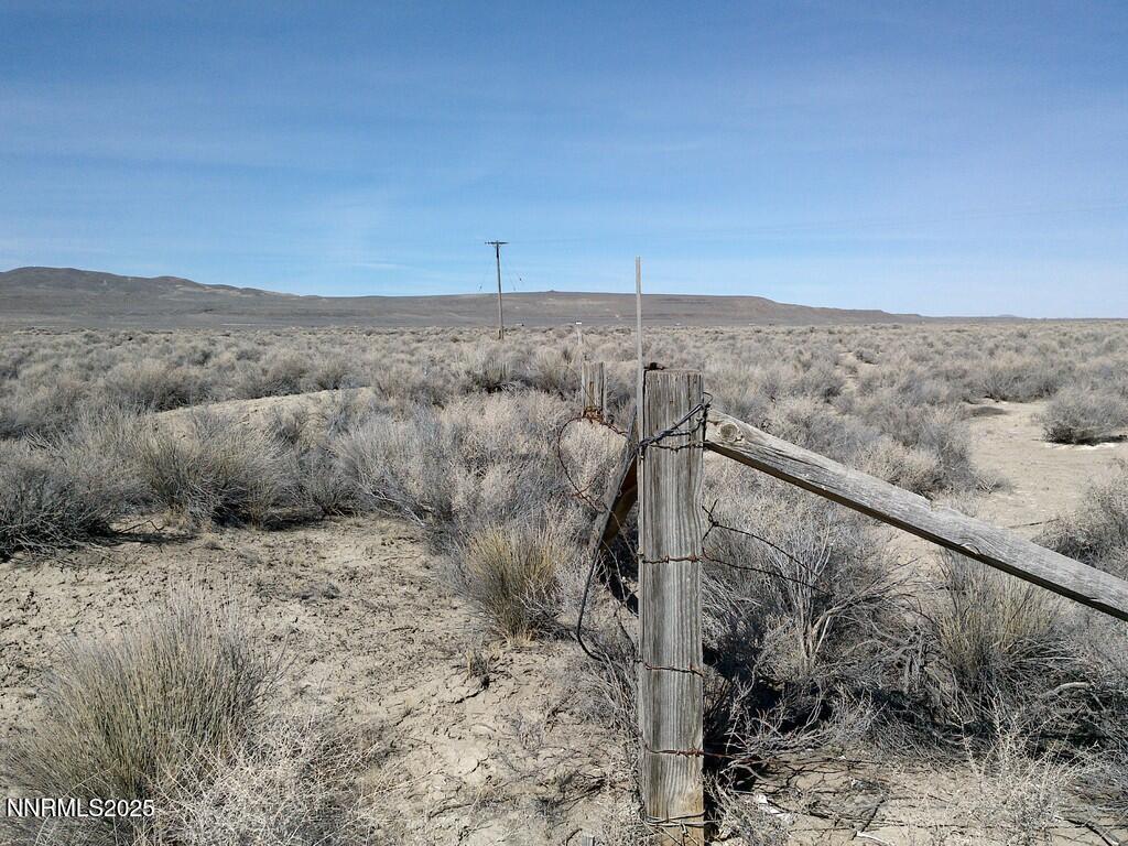 30 7-381-08 Lovelock, NV 89419 - Photo 16 of 31 a view of a dry yard with trees in the background