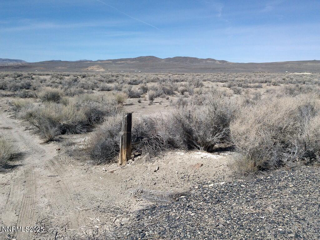 30 7-381-08 Lovelock, NV 89419 - Photo 3 of 31 a view of a dry yard with mountains in the background