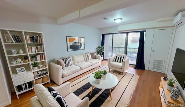 a living room with furniture fireplace and a large window