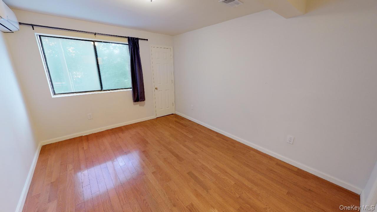 110-19 72nd Road, Unit 3A Queens, NY 11375 - Photo 13 of 20 an empty room with wooden floor and windows