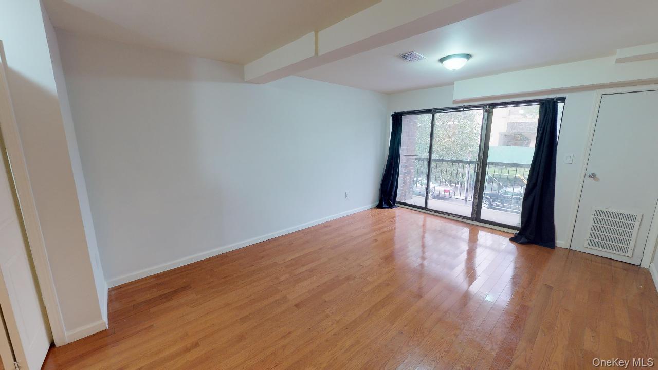 110-19 72nd Road, Unit 3A Queens, NY 11375 - Photo 2 of 20 wooden floor in an empty room with a window