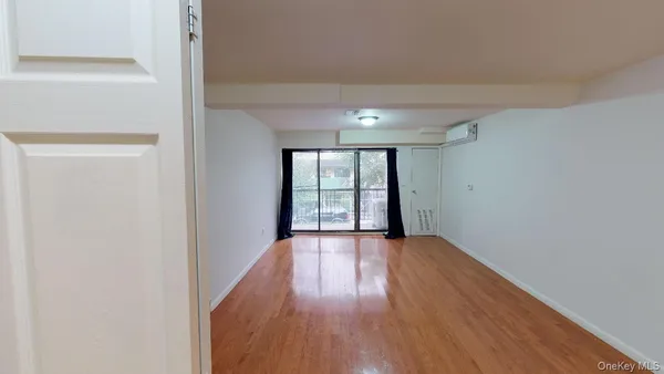 a view of wooden floor and windows in a room