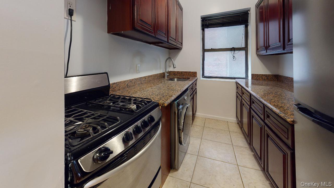 110-19 72nd Road, Unit 3A Queens, NY 11375 - Photo 9 of 20 a kitchen with granite countertop a stove and a sink