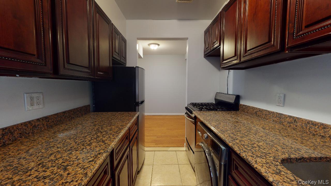 110-19 72nd Road, Unit 3A Queens, NY 11375 - Photo 10 of 20 a kitchen with granite countertop cabinets stainless steel appliances and a counter space