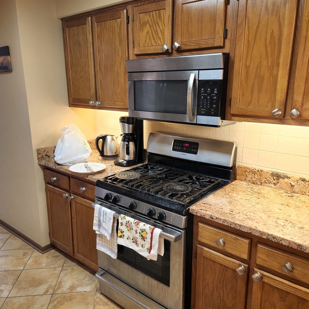 6441 West Warner Avenue, Unit 506 Chicago, IL 60634 - Photo 4 of 15 a stove top oven sitting inside of a kitchen