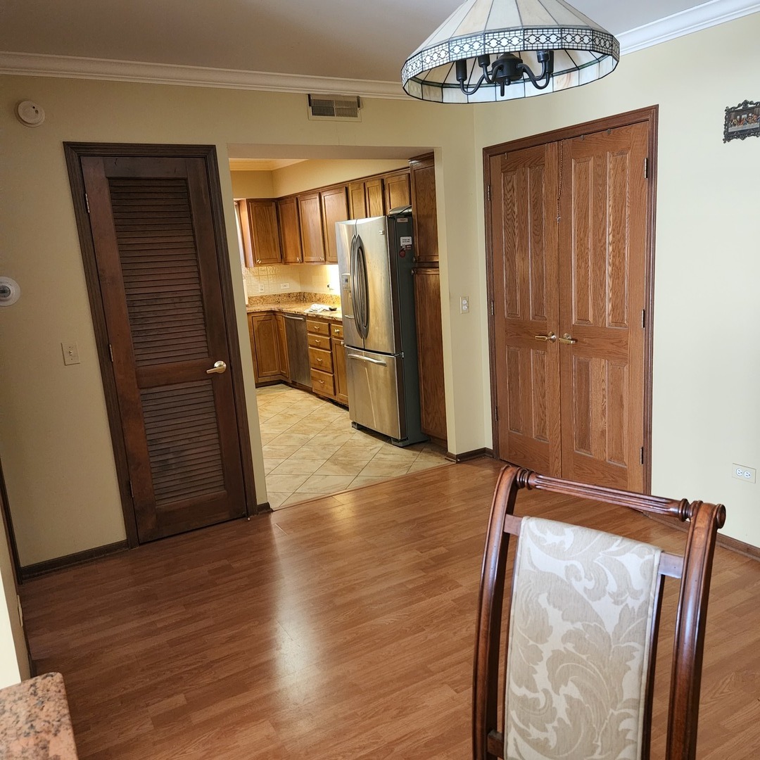 6441 West Warner Avenue, Unit 506 Chicago, IL 60634 - Photo 9 of 15 a view of a refrigerator in kitchen and wooden floor