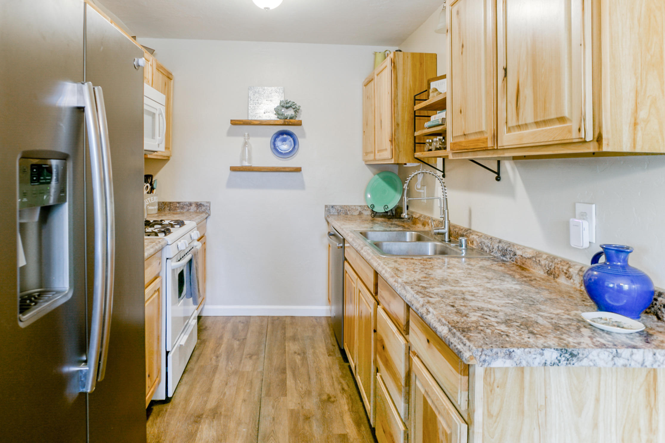 2498 Saturn Redding, CA 96002 - Photo 14 of 40 a kitchen with granite countertop a sink a stove and refrigerator