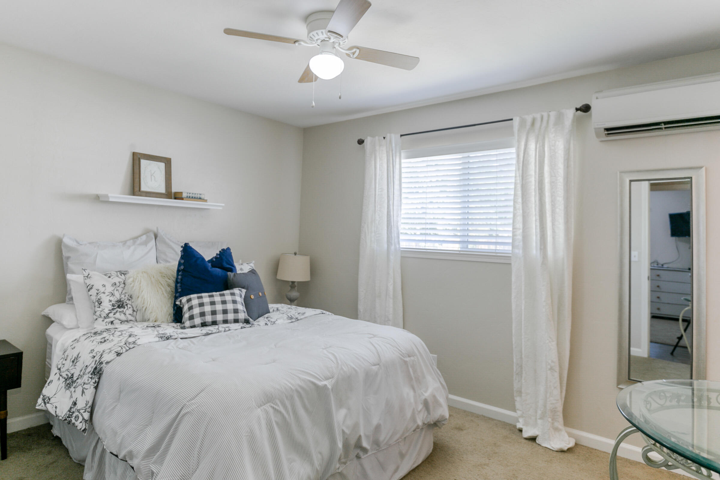 2498 Saturn Redding, CA 96002 - Photo 24 of 40 a bedroom with a large bed and a chandelier