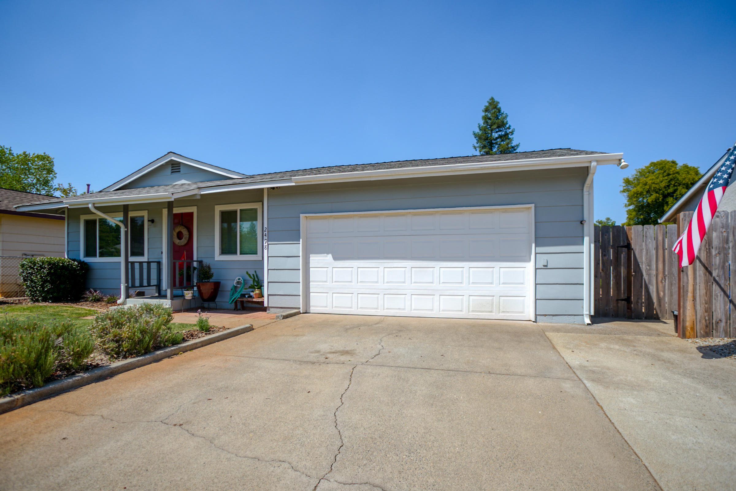 2498 Saturn Redding, CA 96002 - Photo 3 of 40 a front view of house with yard and trees in the background
