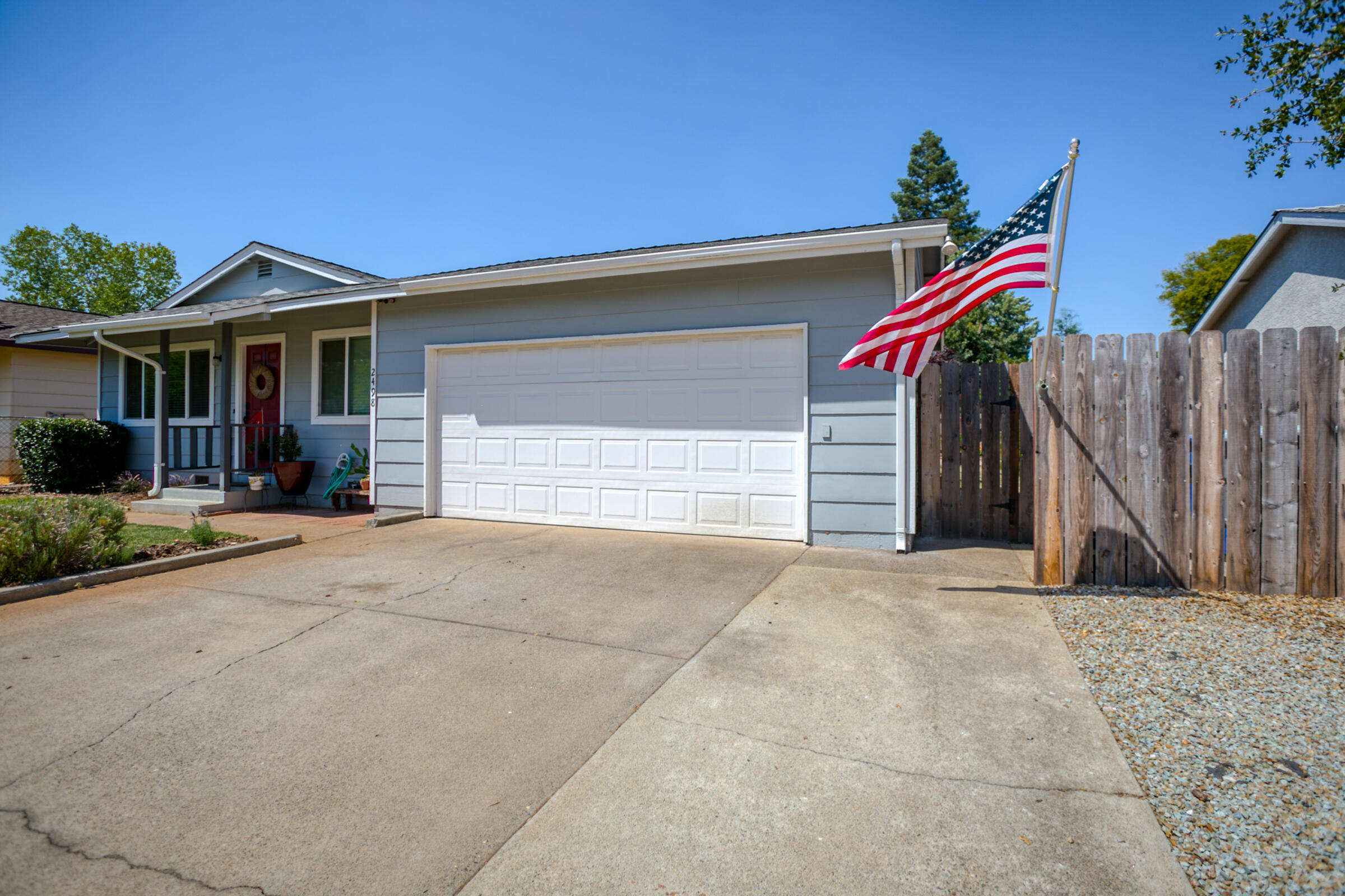 2498 Saturn Redding, CA 96002 - Photo 4 of 40 a view of a house with a yard and garage