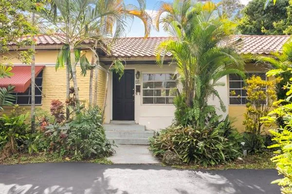 a front view of a house with a garden