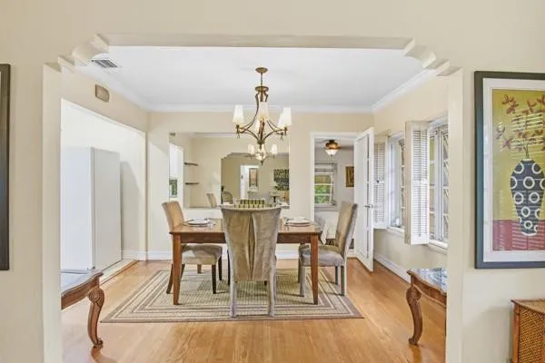 a view of a dining room with furniture and a chandelier
