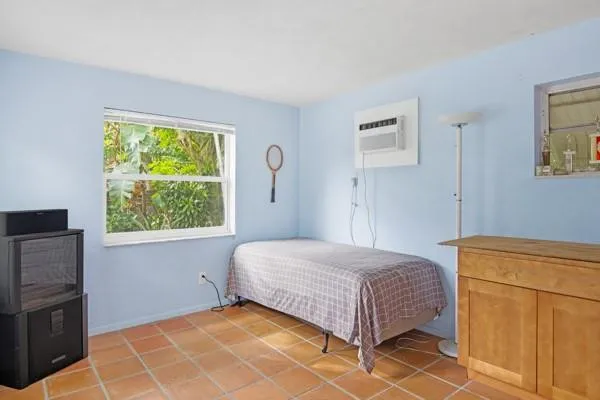 a bedroom with a bed and a window