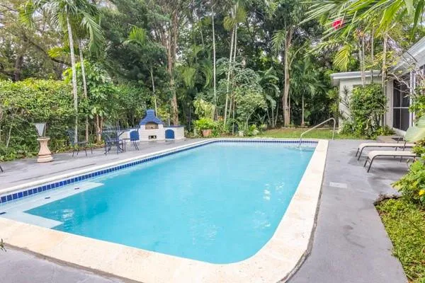 a view of backyard with swimming pool and outdoor seating