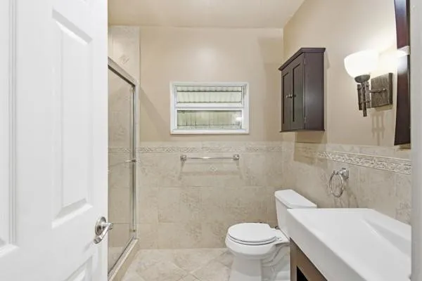 a bathroom with a sink toilet and shower