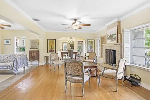 a view of a livingroom with furniture a chandelier and wooden floor