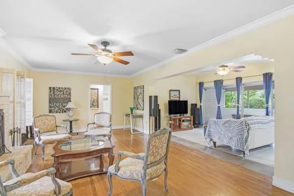 a living room with furniture and large windows