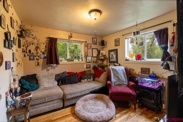 a living room with furniture fireplace and a large window