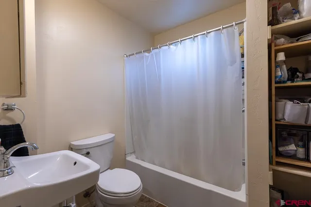 a white toilet sitting next to a bathroom sink