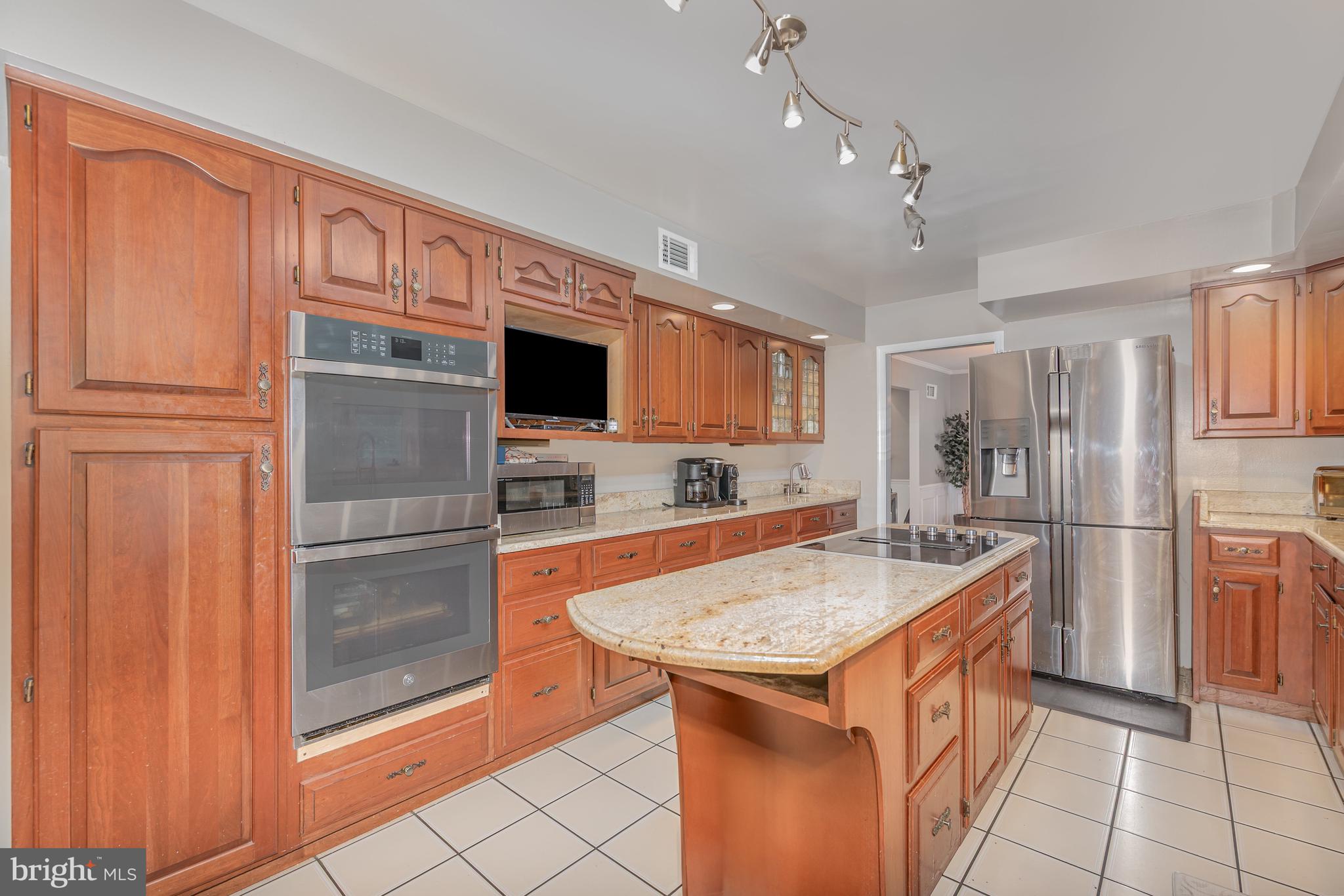 5214 Forge Road Perry Hall, MD 21128 - Photo 12 of 35 a kitchen with stainless steel appliances granite countertop a refrigerator and a sink