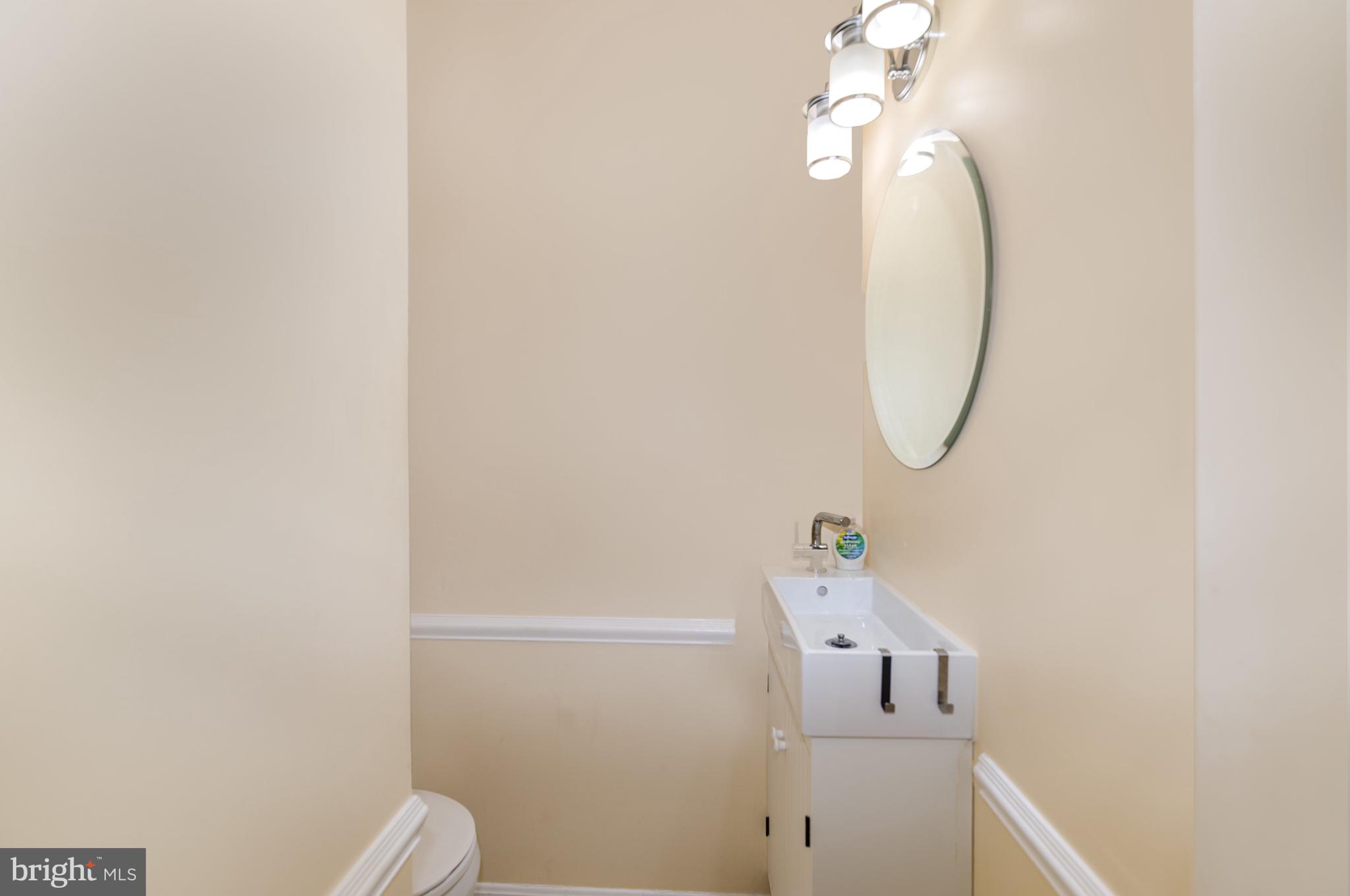 5214 Forge Road Perry Hall, MD 21128 - Photo 17 of 35 a bathroom with a light fixture and a mirror