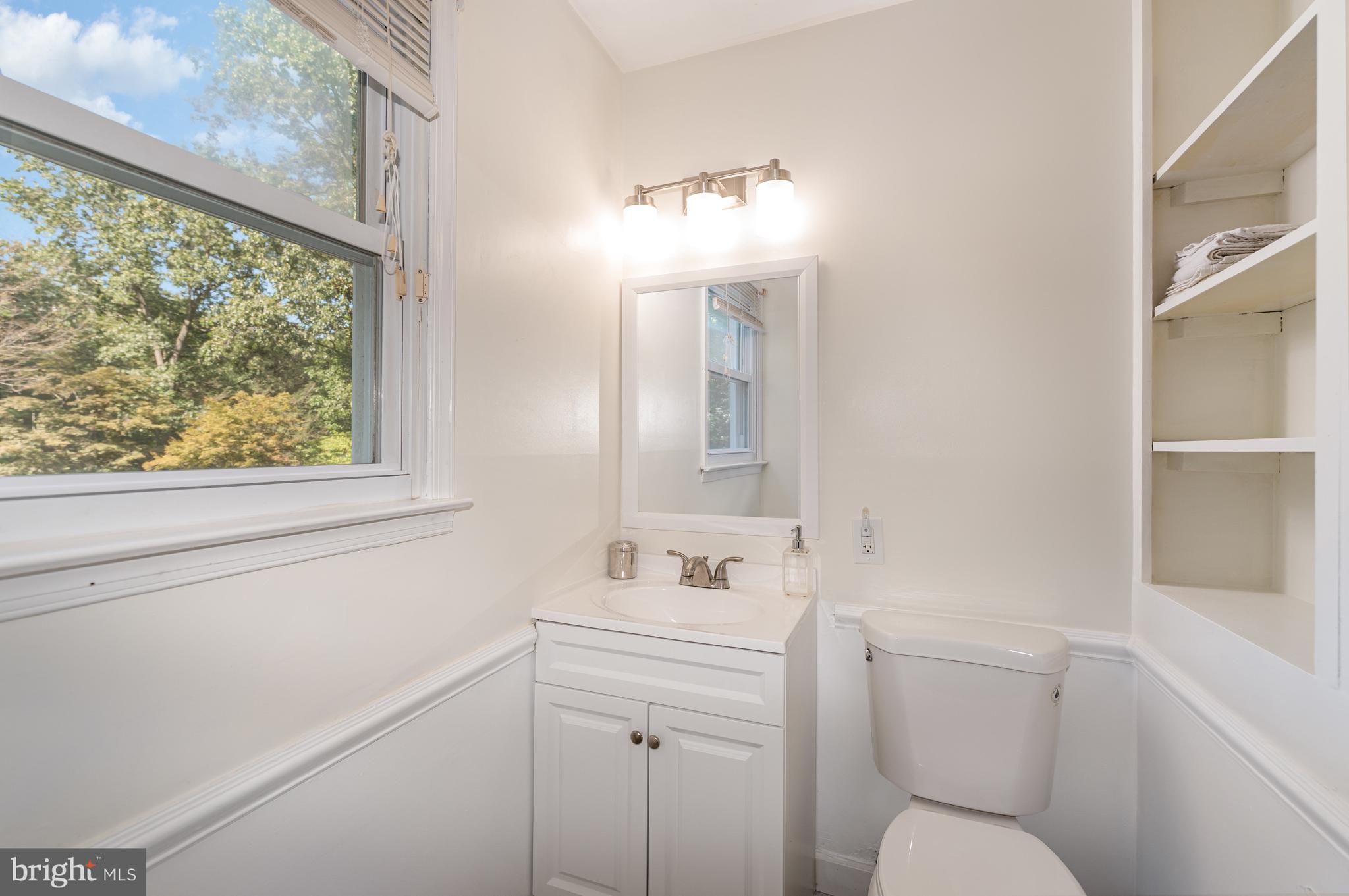 5214 Forge Road Perry Hall, MD 21128 - Photo 23 of 35 a bathroom with a toilet sink vanity and mirror
