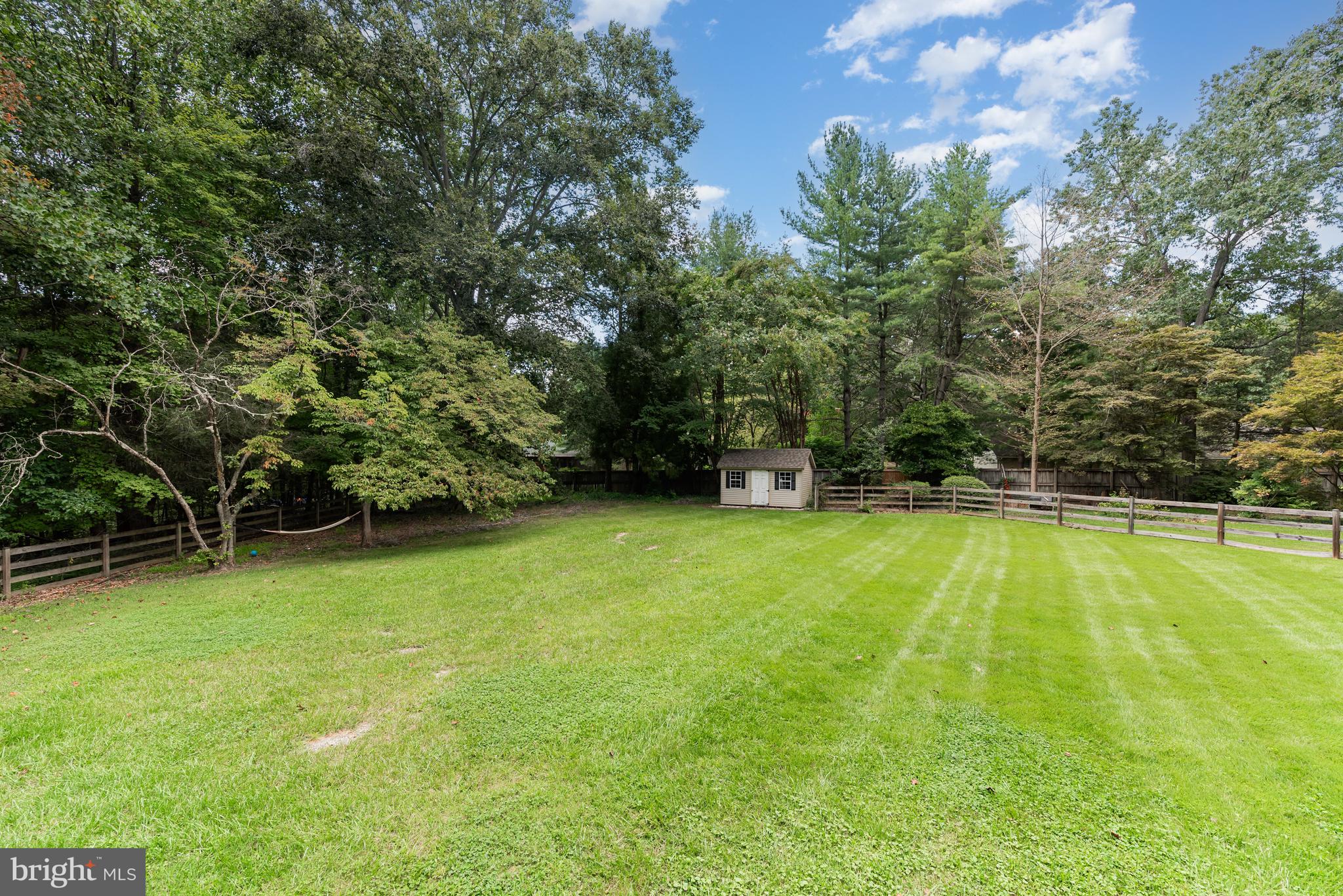 5214 Forge Road Perry Hall, MD 21128 - Photo 32 of 35 a view of a swimming pool with a yard and large trees