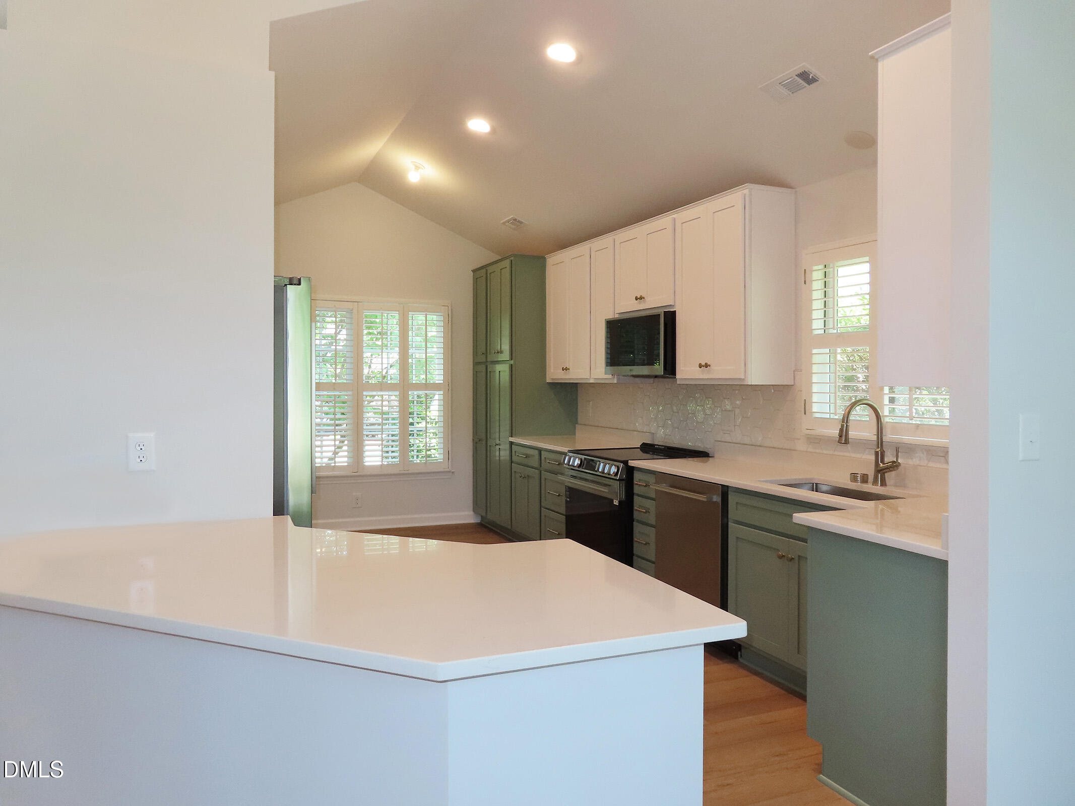 120 Weatherhill Point Carrboro, NC 27510 - Photo 5 of 25 a kitchen with a sink a stove top oven and white cabinet