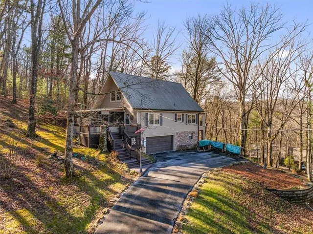 a view of a house with a yard covered in snow