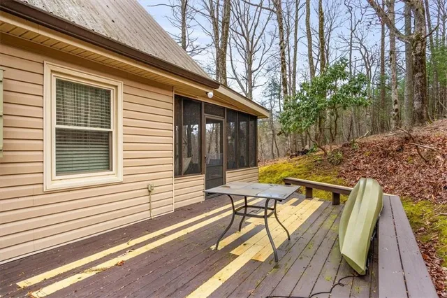 a view of backyard with a deck and wooden floor