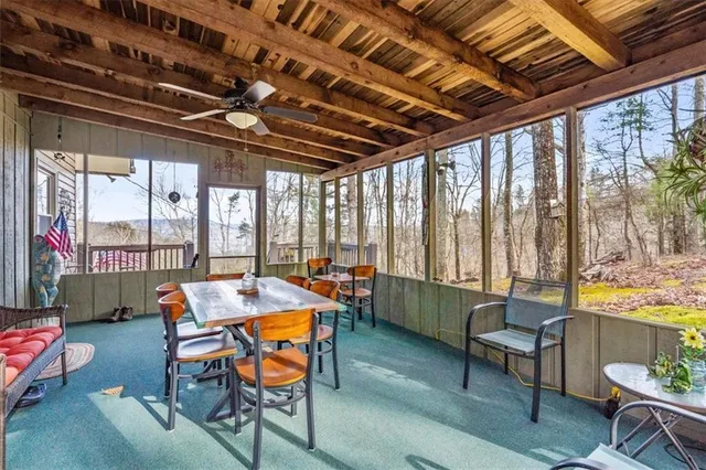 a balcony with wooden floor and outdoor seating